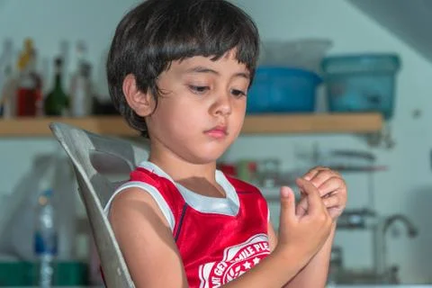 A boy sitting in the kitchen Stock Photos