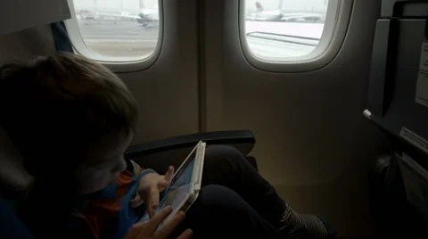 Boy sitting in the plane and using tablet PC Stock-Footage 45083772