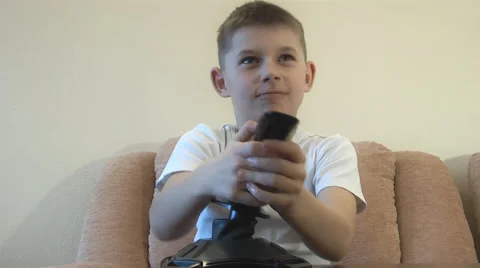 Boy sitting playing on the computer with a joystick. Expressing emotions Stock Footage 48333064