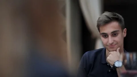 Boy sitting in restaurant Stock Footage 79799432