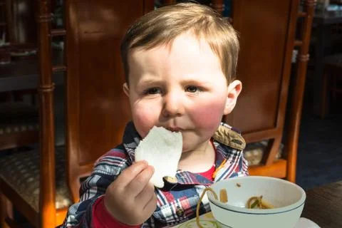 Boy sitting in a restaurant. Stock Photos