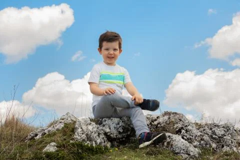 Boy sitting on the rock Stock-Fotos