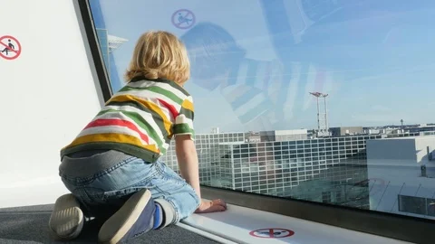 Boy is Sitting in the SkyLine and Looking Outside. Stockbeeldmateriaal 97202512