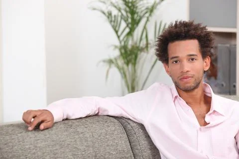 Boy sitting on sofa Stock Photos