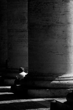 Boy sitting in a stone column Stock Photos