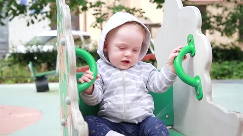 A boy is sitting on a swing Stock Footage 134256559