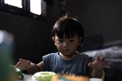 Boy Sitting On Table And Playing Toy Blocks Stock Photos