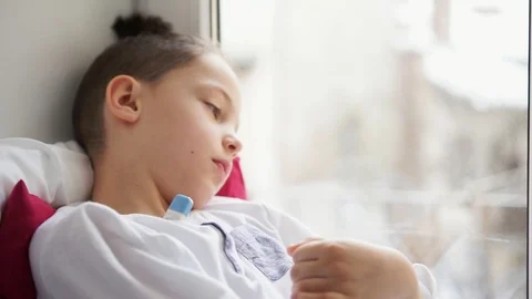 Boy sitting on window sill and measure the temperature Stock Footage 91171544