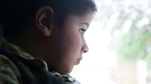 Boy sitting at the window in sneakers Stock Footage 75811977