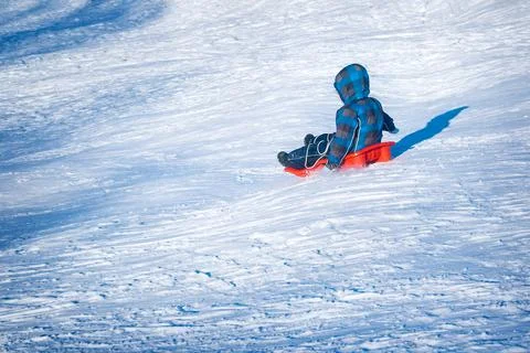 Boy on sled Stock Photos