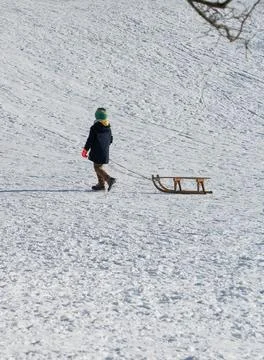 Boy with sled in the snow Stock Photos
