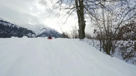 Boy sledding down small hill in bavaria Stock Footage 121754124