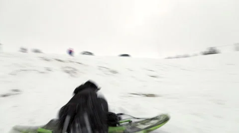 Boy sledding towards camera off jump Stock Footage 45021263