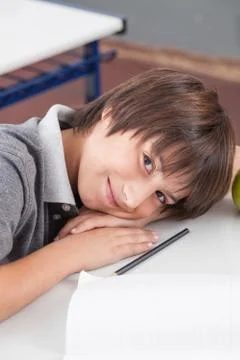 Boy sleeping in class Фото