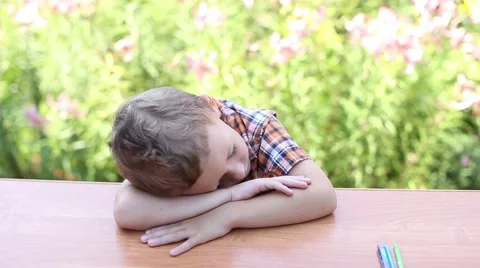 Boy sleeping on desk Stock Footage 59899502