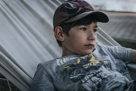 Boy sleeping in a hammock, summer time, holiday time. Soft selective focus. Stock Photos