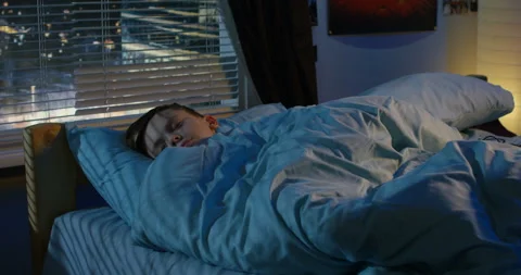 Boy sleeping in his bed Stock Footage