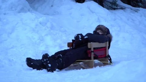 Boy sleeping on snow/sled Stock Footage 151566893