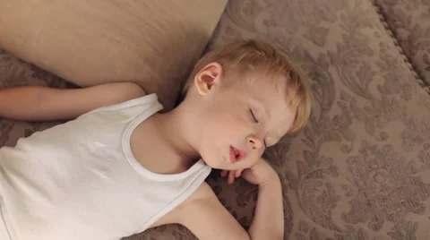 Boy Sleeping on a Sofa Among the Toys Plane Video stock 67896407