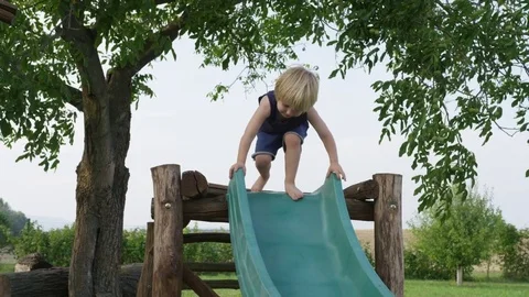 Boy Slide Alone - 4k - Slow motion Stock Footage 70447865