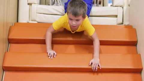 Boy slide down the staircase on belly. Stock Footage 264495583