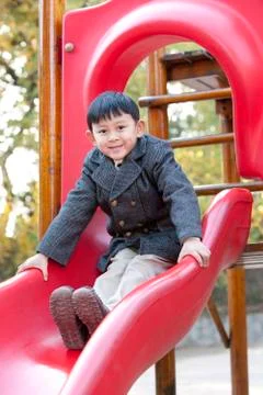 Boy on a slide Stock Photos
