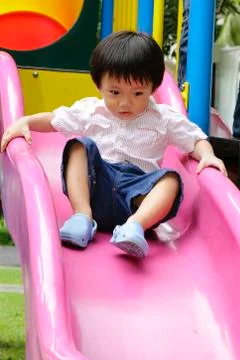 Boy on slide Stock Photos