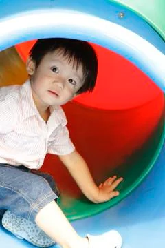 Boy on slide Stock Photos