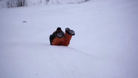 Boy slides down the mountain on an sleigh, winter sport, activity 스톡 동영상 211626010