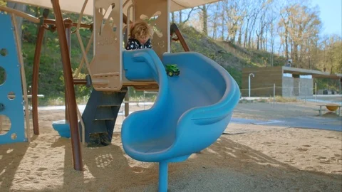 The boy slides down a toy car Stock-Footage 76010579