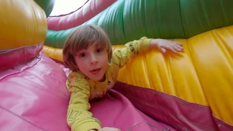 Boy sliding on Bouncy Castle Stock-Footage 113456822