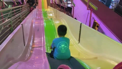 Boy Sliding Down Carnival Ride Slide Tower At Night Stock-Footage 237676874
