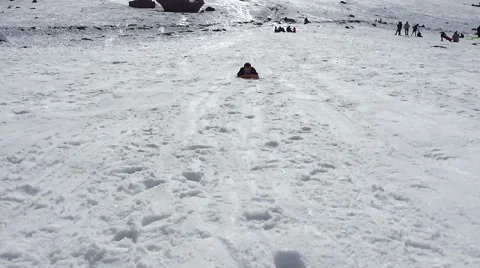 Boy sliding down on a sled - snow mountain Video stock 58923012
