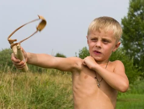 Boy with a slingshot. Stock Photos