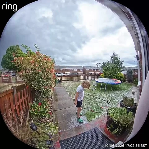 Boy Slips on Hail-Covered Trampoline, Rochester, UK - 10 Jun 2026 Stock Footage 337602146