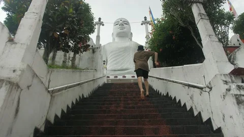 A boy in slowmotion running | A Buddha statue, temple in Kandy | Srí lanka Stock Footage 167120076