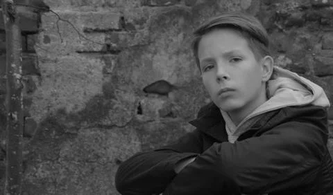 A boy with a smart look looks at the camera. Stock Photos