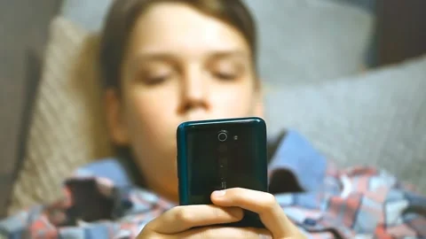 The boy with smartphone lying on the couch. Internet concept, messages Stock Footage 153867209