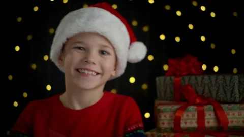 The boy smiles and claps his hands during the Christmas holidays. Video stock 295231353