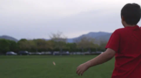 Boy smiles and then throws frisbee Video stock 37408631