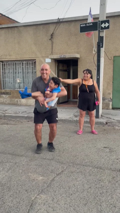 Boy Smiles Big While Playing Jump Rope With Dad, Renca, Chile - 18 Jan 2024 Stock Footage 265491638
