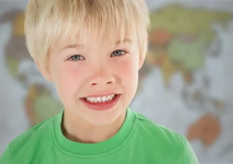 Boy smiling against blurry map Stock Photos