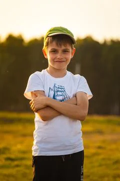 Boy smiling on the background of the forest at sunset Stock Photos