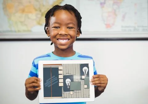 Boy smiling with tablet on his hands, showing the draw of the office on his Stock Photos