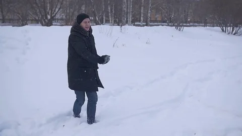 Boy smiling throwing snow Видео 72249394