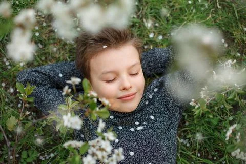 Boy is smiling while laying on the grass Stock Photos