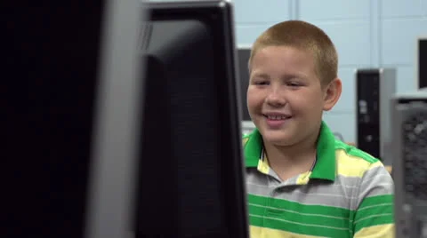 Boy smiling while using computer lab at school Video stock 26584144