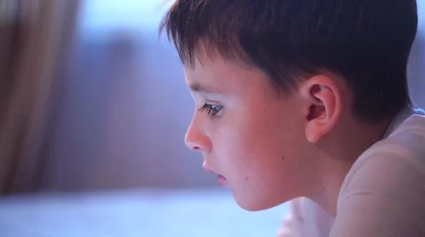 Boy On Sofa Playing With Digital Tablet in Slow Motion Stock Footage 58887860