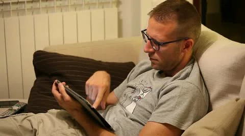 A boy on sofa with tablet Stock Footage 11235764
