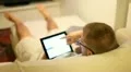 A boy on sofa with tablet HD Footage